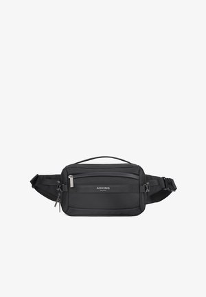 Zwarte nylon heuptas met verstelbare band, ritsvakjes, gestructureerd oppervlak en accent met logo aan de voorkant. Compact rechthoekig ontwerp.