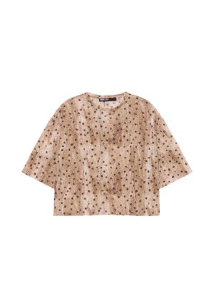 Haut court marron à pois noirs, encolure ronde et larges manches courtes, posé à plat sur fond blanc.