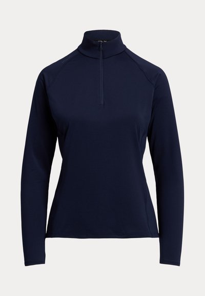 Marineblå langærmet pullover med høj krave og front lynlås til midt, designet til en tætsiddende silhuet.