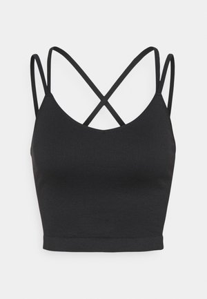 Mustat lyhyet topit, joissa on ribbikuvio ja V-pääntie. Takana ohuet ristiin rististyvät hihnat. Saumaton viimeistely helman kohdalla.