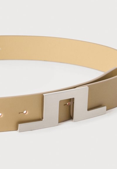 Ζώνη από ταμπά δέρμα με ασημί μεταλλική αγκράφα σε σχήμα τριών συνδεδεμένων ορθών γωνιών, σε λευκό φόντο.