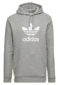 Šedá bavlněná mikina s kapucí, s přední kapsou, stahovací šňůrkou a velkým bílým logem Adidas trefoil umístěným na hrudi.