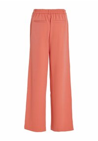 Culotte-Hosen in Koralle, aus glattem Stoff gefertigt. Mit elastischem Bund und zwei Taschen auf der Rückseite. Minimalistisches Design mit klaren Linien.