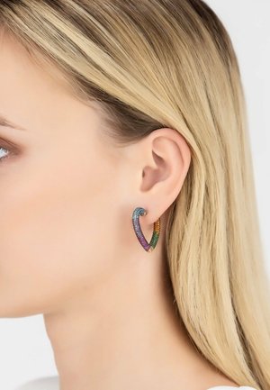 Rainbow-colored heart-shaped earring with textured metallic finish, featuring multi-hued gems and a sleek, open design.