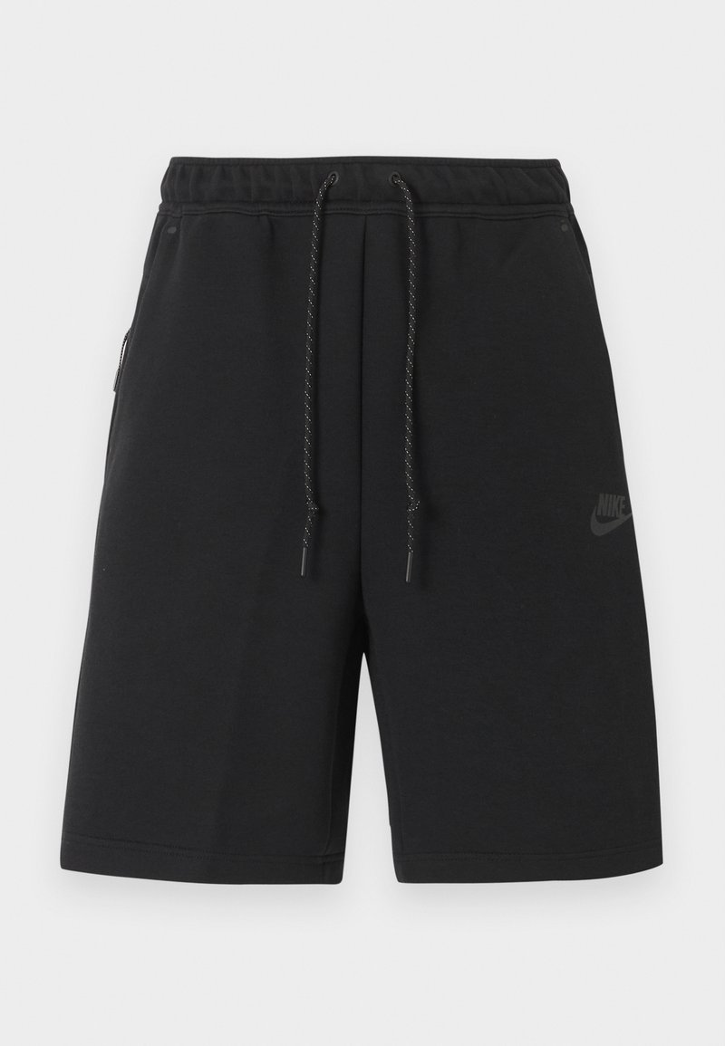 Shorts de sport noirs Nike avec taille élastique, cordon de serrage, poches latérales et logo discret sur la cuisse gauche.