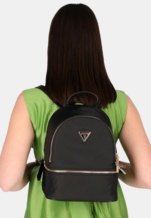 Schwarzer Nylon-Rucksack mit abgerundeter Form, silbernem Reißverschluss und einem dreieckigen Logo. Das Design verfügt über einen oberen Griff und verstellbare Träger.