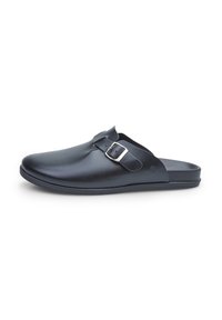 Fekete szintetikus slip-on klumpa lekerekített orral, állítható ezüst csattal és texturált felsőrésszel, lapos talppal.