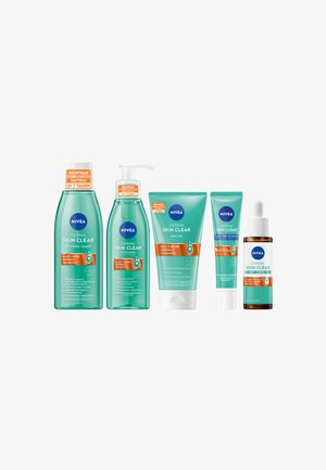 Set of five NIVEA skin care products in turquoise packaging. Includes a toner, cleanser, peeling, serum, and a restorative dropper bottle.
