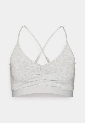 Pilka bralete iš minkštos medžiagos, su susmulkintu priekiu, reguliuojamomis kryžminėmis nugaros petnešėlėmis ir lygiu elastingu juostele apačioje.