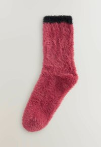 Single fuzzy pink sock with a black cuff lying flat against a light background.