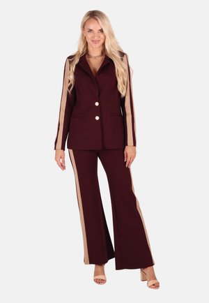 Burgundy tailored blazer and wide-leg pants featuring tan side stripes, two gold buttons, and pockets; smooth fabric with tailored fit.