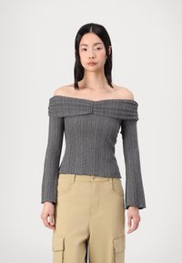 Off-the-shoulder, gray ribbed top with long sleeves and a gathered detail at the neckline, paired with beige cargo pants.