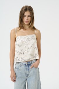 Cream-colored, sleeveless top featuring a textured fabric with wavy silver patterns. It has thin straps and a loose, flowing design.