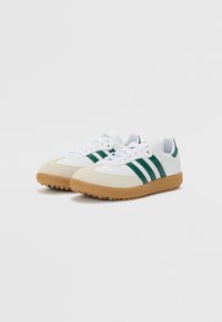 White sneakers with green stripes, made of leather and suede, featuring a rubber gum sole and rounded toe design.