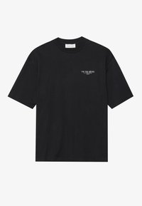 Black cotton t-shirt with short sleeves and a crew neck. Features white text print on the left chest: "VIS TES RÊVES LA TOUR EIFFEL PARIS."