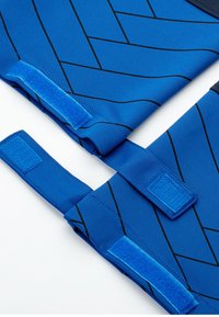 Blue fabric with a herringbone pattern, featuring black lines. Includes Velcro straps in matching blue, with a smooth, textured finish.