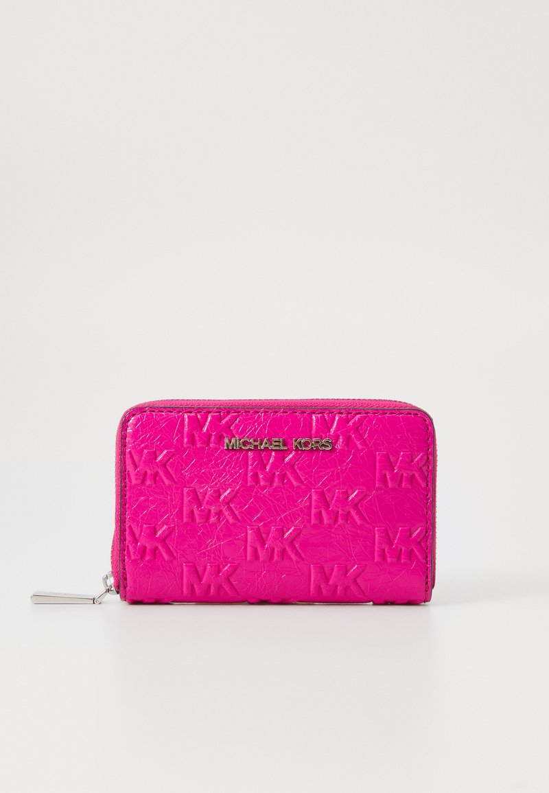 Pink leather wallet with embossed "MK" pattern, zip closure, and gold "MICHAEL KORS" logo on the front. Smooth texture, rectangular shape.
