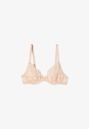 Reggiseno rosa chiaro in pizzo con ferretto, spalline regolabili e un piccolo fiocco centrale, disteso su uno sfondo bianco.