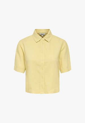 Kortærmet, gul skjorte med knapper og krave, kropsnær pasform og et "ONLY"-mærke inde i halsudskæringen.