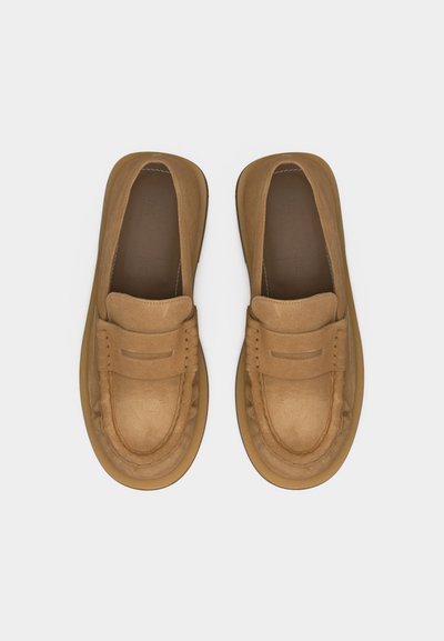 Paire de mocassins slip-on en cuir marron clair avec couture moc toe et détail de bride sur l'avant, vue de dessus sur fond blanc.