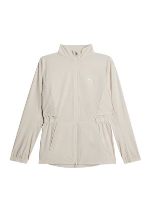 Hellbeige Jacke mit Reißverschluss, langen Ärmeln, elastischen Bündchen, Seitentaschen, Stehkragen und kleinem weißem Logo auf der Brust.
