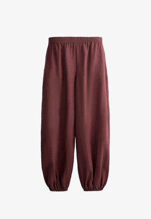 Lässige, kastanienbraune Hose mit elastischem Bund und elastischen Bündchen, aus leichtem Stoff gefertigt.