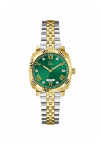 Reloj de metal dorado y plateado con caja cuadrada, esfera verde, números romanos, acentos de diamante y función de día y fecha a las 6 en punto.