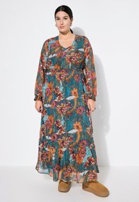 Blumen-Maxi-Kleid mit gerafftem Oberteil in Türkis-, Orange- und lila Mustern. Lange Ärmel, leichtes Material und fließende Silhouette.
