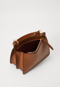 Brown leather handbag with a structured design, gold hardware, a zippered compartment, and a contrasting dark interior.