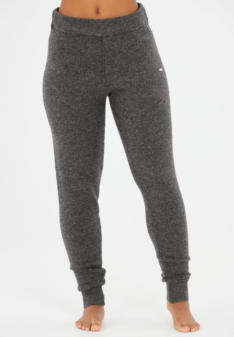 Gray, fitted sweatpants made from a soft, textured fabric. Features a wide, ribbed waistband and tapered cuffs at the ankles.