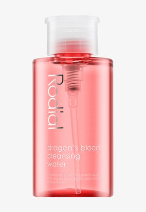 Clear plastic bottle with a pink liquid, featuring a white pump top and silver lettering that reads "Rodial dragon's blood cleansing water."