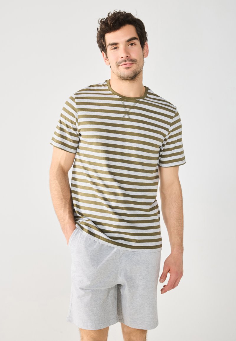 Olive green and white striped short-sleeve t-shirt with a round neckline, paired with light grey shorts featuring side pockets.