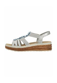 Sandales argentées avec une semelle en liège, dotées de brides élastiques et d'une décoration florale bleue et blanche sur le devant.