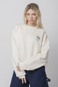 Κρέμα κουκούλα με χαμηλούς ώμους και μακριά μανίκια, με μπλε καρτούν γραφικό στο στήθος. Μαλακή υφή υφάσματος.