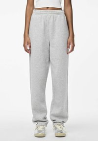 Grey sweatpants made of soft fabric, featuring an elastic waistband and a relaxed fit. Cuffs are slightly gathered at the ankles.