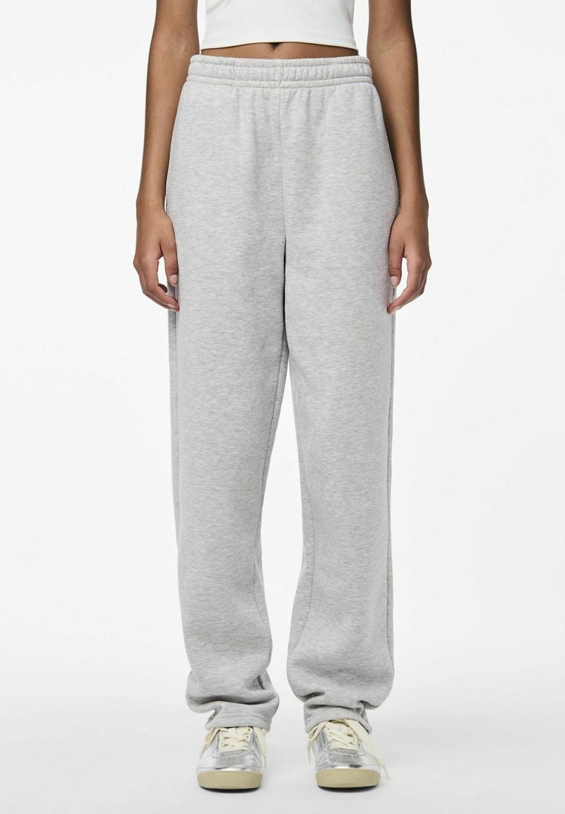 Grey sweatpants made of soft fabric, featuring an elastic waistband and a relaxed fit. Cuffs are slightly gathered at the ankles.