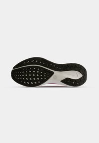 Black rubber outsole with textured grip pattern; white midsole with subtle pink accents. Smooth edges; overall athletic shoe design.