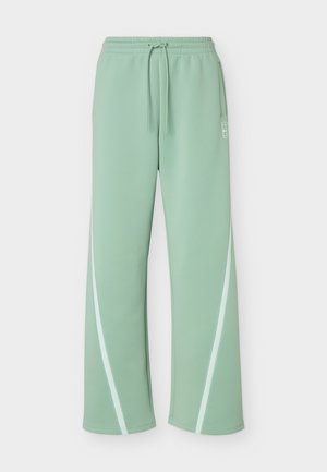 Light green wide-leg track pants with elastic waistband, drawstring, side pockets, and white curved stripes on the legs.
