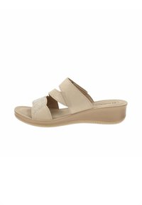 Sandali a zeppa beige con due cinturini in velcro e una parte superiore decorata con strass. Materiale in tessuto morbido e suola in gomma testurizzata per una migliore aderenza.