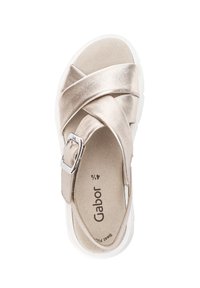 Metallic gold cross-strap sandal with a buckle, cushioned insole, and white rubber sole. Smooth texture with a minimalist design.