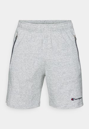 Pantalones cortos deportivos grises con cintura elástica, cremalleras laterales y un logotipo de texto en el dobladillo. Tejido suave con textura jaspeada.