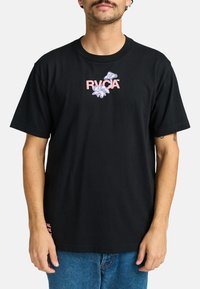 Black cotton t-shirt featuring pink and blue floral graphics with "RVCA" logo at the center; short sleeves, crew neckline.