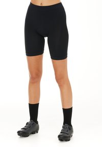 Zwarte fietsbroek van soepel, rekbaar materiaal en een aansluitend ontwerp, met een brede tailleband en een lengte tot halverwege de dij.