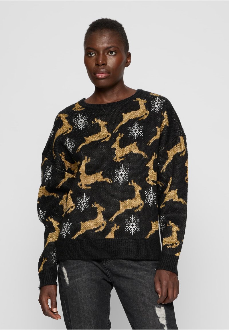 Pull en maille noire avec motifs de rennes dorés et flocons de neige blancs. Il présente une coupe décontractée et des détails côtelés aux poignets et à l'ourlet.