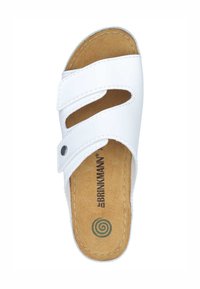 White slide sandal with dual adjustable straps, cork insole, and a circular logo on the footbed. Smooth synthetic upper material.