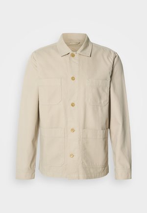 Beige bomullsjakke med knappet front, to brystlommer og to sidelommer. Har en klassisk krage og lange ermer.