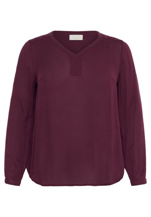 Blouse bordeaux à manches longues avec un col en V, tissu texturé, et poignets ajustés avec de légères fronces. L'étiquette indique "KAFFE."