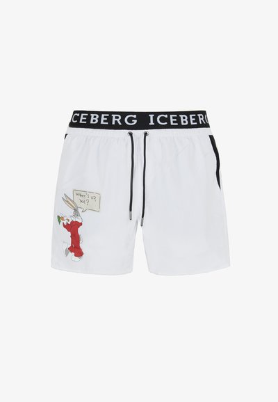 Pantaloni da bagno bianchi con una vita elastica nera che presenta il nome del marchio "ICEBERG." Include un design con un personaggio dei cartoni e dettagli testuali.