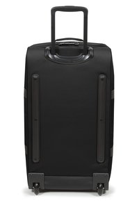 Valigia rigida nera con manico telescopico, due ruote lisce e quattro scanalature orizzontali sul retro. Design robusto con superficie testurizzata.