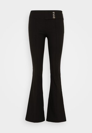 Pantalons évasés noirs en tissu extensible, dotés d'une taille lisse, de deux boutons métalliques à l'avant et d'une poche zippée sur le côté.